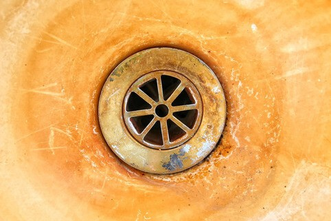 Sink basin stained orange and brown from iron and rust in well water