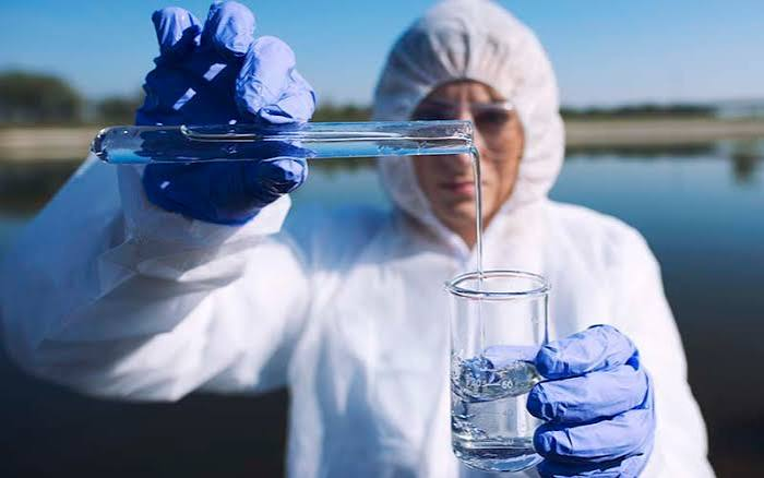 Laboratory water sample vial being analyzed