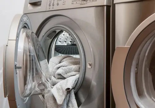 Front-load washing machine with towels — hard water shortens appliance life
